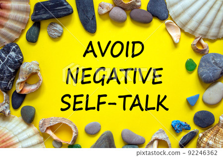 Avoid negative self-talk symbol. Concept words Avoid negative self-talk on a beautiful yellow background. Sea stones and seashells. Psychological and Avoid negative self-talk concept. Copy space. 92246362