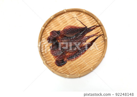 Dried octopus on a bamboo basket on a white background Dried octopus on a bamboo basket on a white background 92248148
