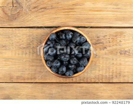 Fresh blueberries in the bowl on a wooden table. Fresh blueberries in the bowl on a wooden table. 92248179