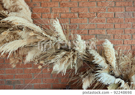 Macro photography of flowers and plants, yellow ears of rye and wheat on a white background, dried flowers for home decor, 8 march, selective focus. Macro photography of flowers and plants, yellow ears of rye and wheat on a white background, dried flowers for home decor, 8 march, selective focus. 92248698
