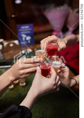 Celebrating with glasses of alcohol in hands. Happy female friends having good time. Celebrating with glasses of alcohol in hands. Happy female friends having good time. 92248706