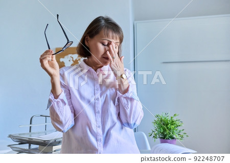 Mature tired woman experiencing stress headache depression Mature tired woman experiencing stress headache depression 92248707