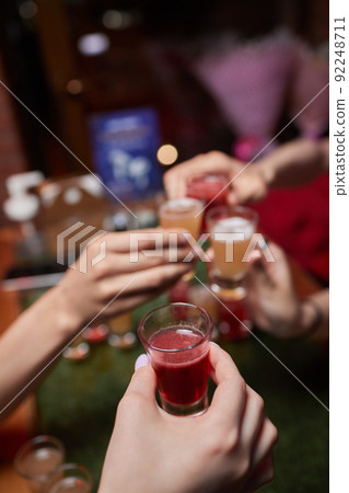 Celebrating with glasses of alcohol in hands. Happy female friends having good time. Celebrating with glasses of alcohol in hands. Happy female friends having good time. 92248711