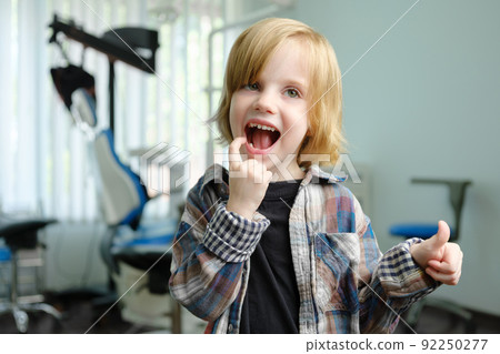 Portrait of cute boy in dental cabinet Portrait of cute boy in dental cabinet 92250277