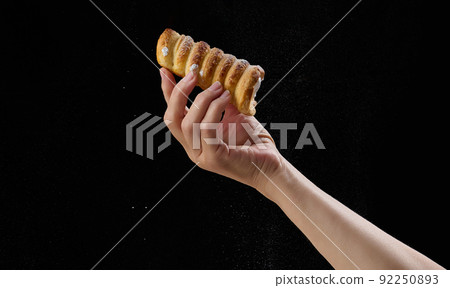 Baked tubes with whipped protein cream in a female hand Baked tubes with whipped protein cream in a female hand 92250893