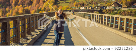BANNER, LONG FORMAT Montenegro. Woman touriste in background of Dzhurdzhevich Bridge Over The River Tara foggy morning. Travel around Montenegro concept. Sights of Montenegro 92251286