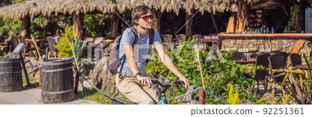 Man tourist on a bicycle explores Budva in Montenegro. Cycling in Montenegro concept BANNER, LONG FORMAT Man tourist on a bicycle explores Budva in Montenegro. Cycling in Montenegro concept BANNER, LONG FORMAT 92251361