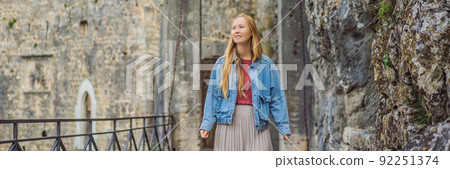 BANNER, LONG FORMAT Woman tourist enjoying Colorful street in Old town of Kotor on a sunny day, Montenegro. Travel to Montenegro concept BANNER, LONG FORMAT Woman tourist enjoying Colorful street in Old town of Kotor on a sunny day, Montenegro. Travel to Montenegro concept 92251374