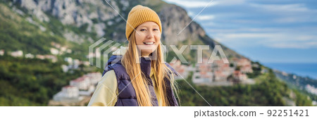 BANNER, LONG FORMAT Woman in the mountains of Montenegro in warm clothes. Travel to Montenegro in spring, autumn, winter BANNER, LONG FORMAT Woman in the mountains of Montenegro in warm clothes. Travel to Montenegro in spring, autumn, winter 92251421