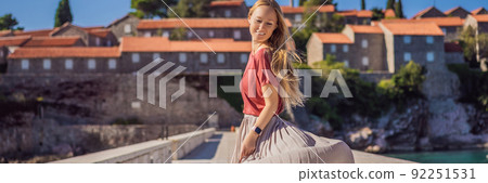 BANNER, LONG FORMAT Woman tourist on background of beautiful view of the island of St. Stephen, Sveti Stefan on the Budva Riviera, Budva, Montenegro. Travel to Montenegro concept BANNER, LONG FORMAT Woman tourist on background of beautiful view of the island of St. Stephen, Sveti Stefan on the Budva Riviera, Budva, Montenegro. Travel to Montenegro concept 92251531