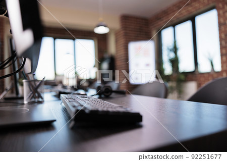 Empty call center reception office with telemarketing equipment on helpdesk. No people at customer service and client support telephony network, with multiple monitors for assistance. 92251677