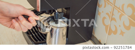 Handsome man using coffee machine in kitchen BANNER, LONG FORMAT Handsome man using coffee machine in kitchen BANNER, LONG FORMAT 92251784