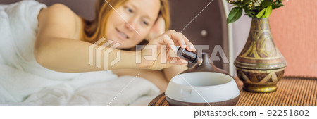 BANNER, LONG FORMAT Aromatherapy Concept. Wooden Electric Ultrasonic Essential Oil Aroma Diffuser and Humidifier. Ultrasonic aroma diffuser for home. Woman resting at home BANNER, LONG FORMAT Aromatherapy Concept. Wooden Electric Ultrasonic Essential Oil Aroma Diffuser and Humidifier. Ultrasonic aroma diffuser for home. Woman resting at home 92251802
