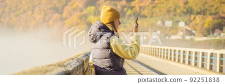 BANNER, LONG FORMAT Montenegro. Woman touriste in background of Dzhurdzhevich Bridge Over The River Tara foggy morning. Travel around Montenegro concept. Sights of Montenegro 92251838