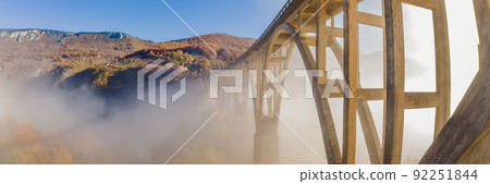 Montenegro. Dzhurdzhevich Bridge Over The River Tara foggy morning BANNER, LONG FORMAT 92251844