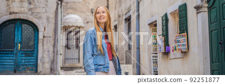 BANNER, LONG FORMAT Woman tourist enjoying Colorful street in Old town of Kotor on a sunny day, Montenegro. Travel to Montenegro concept 92251877