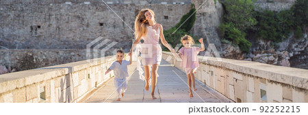 BANNER, LONG FORMAT Mother and two children daughter and son tourists on background of beautiful view St. Stephen island, Sveti Stefan on the Budva Riviera, Budva, Montenegro. Travel to Montenegro BANNER, LONG FORMAT Mother and two children daughter and son tourists on background of beautiful view St. Stephen island, Sveti Stefan on the Budva Riviera, Budva, Montenegro. Travel to Montenegro 92252215