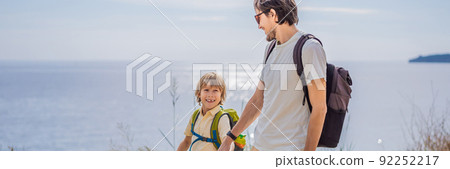 Dad and son tourists walks along the coast of Budva in Montenegro BANNER, LONG FORMAT 92252217