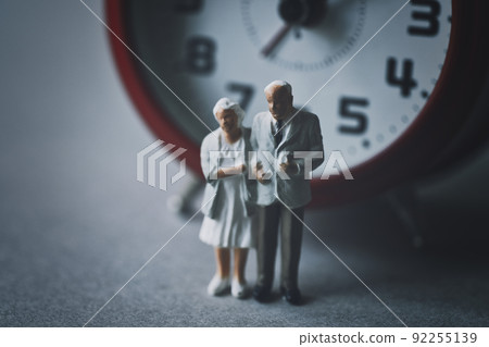 Time and miniature elderly couple 92255139