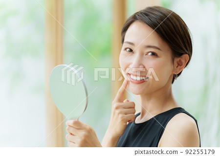Female dental care concept with a hand mirror 92255179
