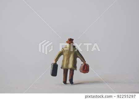 Miniature man with a bag Miniature man with a bag 92255297