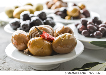 set of selected pickled olives in white bowls 92256613
