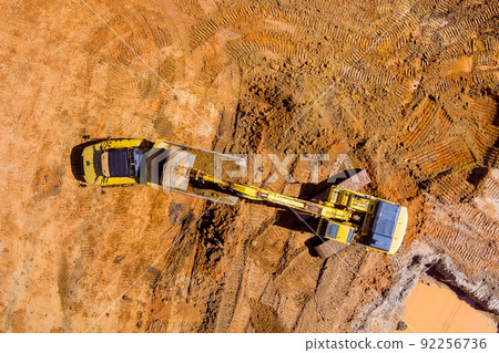 Excavators are used to prepare ground for loading into dump trucks on construction sites by dumping earth with excavators Excavators are used to prepare ground for loading into dump trucks on construction sites by dumping earth with excavators 92256736
