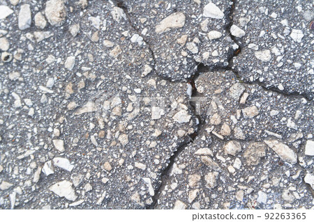 Stone wall with deep cracks. Break in the ground. Drought and consequences. 92263365