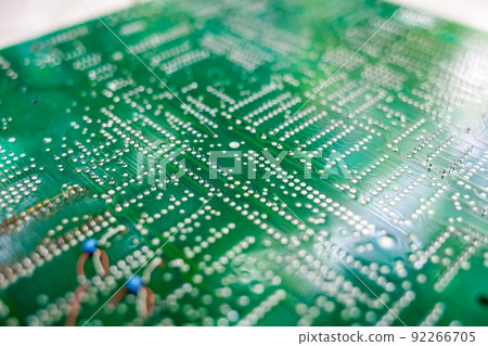 Old computer chips that are out of order. Not working microshops with transistors, chips and conductors. Blue system board with microchips and transistors 92266705