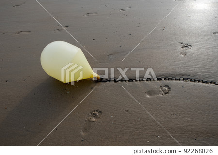 White buoy on a chain with reflection on a beach at low tide in Blankenberge, Belgium White buoy on a chain with reflection on a beach at low tide in Blankenberge, Belgium 92268026