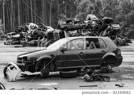 Dump of war-destroyed cars in Ukraine, black and white photo 92269062