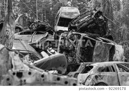 Dump of war-destroyed cars in Ukraine, black and white photo 92269178