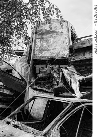 Shot and burned cars during the war in Ukraine, black and white photo 92269363