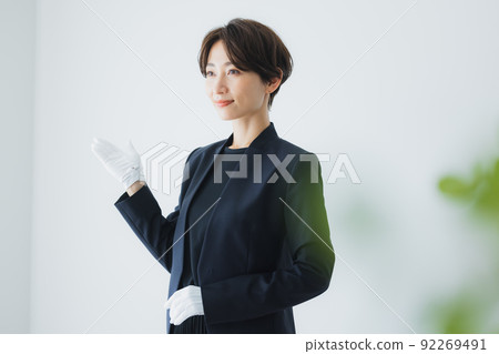 Female staff wearing white gloves 92269491