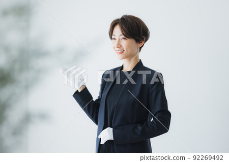 Female staff wearing white gloves 92269492