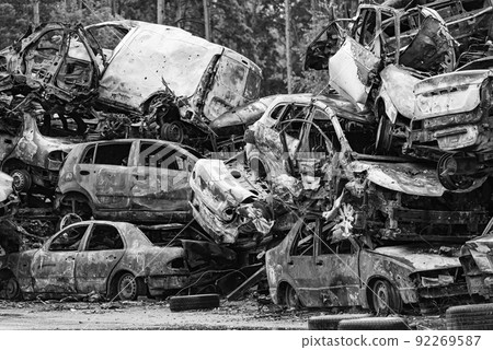 Dump of war-destroyed cars in Ukraine, black and white photo 92269587
