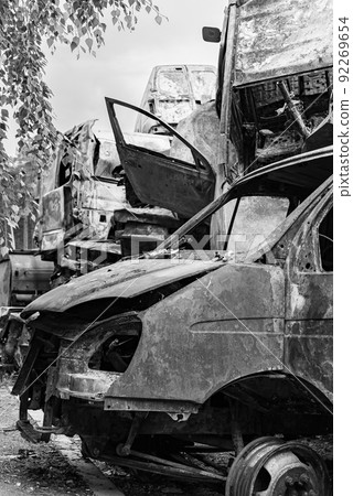 Shot and burned cars during the war in Ukraine, black and white photo 92269654