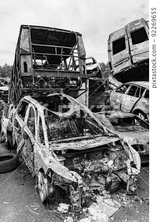 Dump of war-destroyed cars in Ukraine, black and white photo 92269655