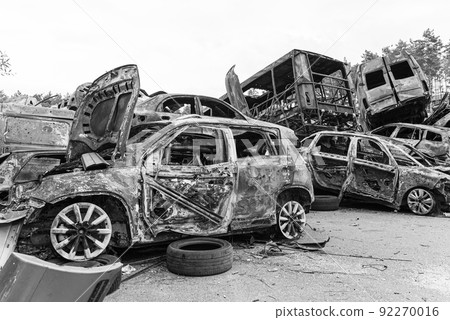 Dump of war-destroyed cars in Ukraine, black and white photo 92270016