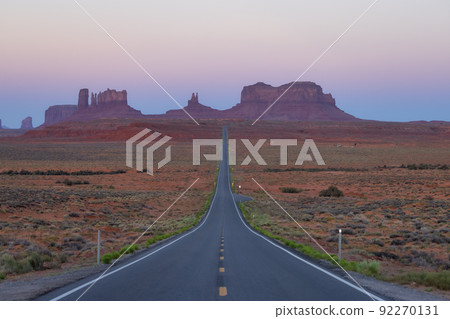 Scenic Road in the Dry Desert with Red Rocky Mountains in Background. Scenic Road in the Dry Desert with Red Rocky Mountains in Background. 92270131