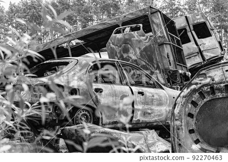 Shot and burned cars during the war in Ukraine, black and white photo 92270463