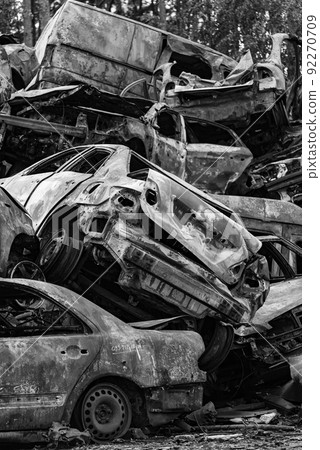 Shot and burned cars during the war in Ukraine, black and white photo 92270709