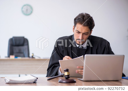 Young male judge working in the courthouse Young male judge working in the courthouse 92270732
