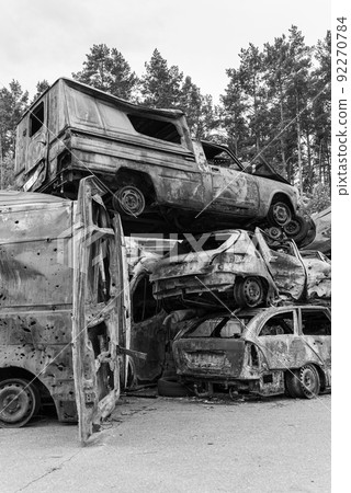 Shot and burned cars during the war in Ukraine, black and white photo 92270784