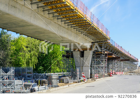 New modern road overpass bridge construction site with lots of scaffolding and concreting frame 92270836