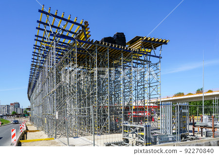 New modern road overpass bridge construction site with lots of scaffolding and concreting frame New modern road overpass bridge construction site with lots of scaffolding and concreting frame 92270840