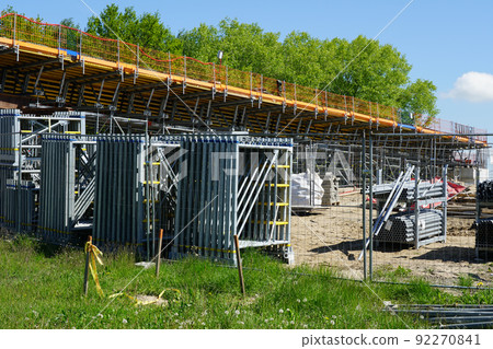 New modern road overpass bridge construction site with lots of scaffolding and concreting frame New modern road overpass bridge construction site with lots of scaffolding and concreting frame 92270841