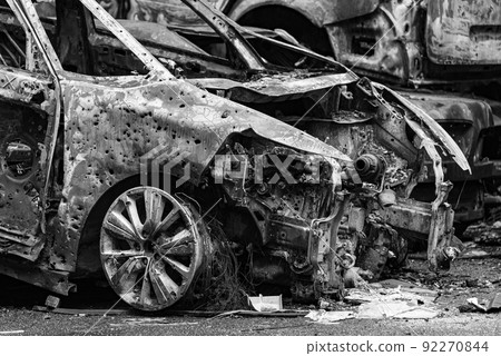 Dump of war-destroyed cars in Ukraine, black and white photo 92270844