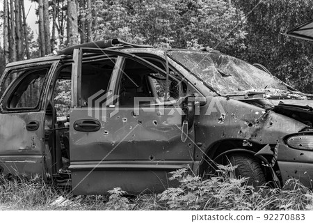 Dump of war-destroyed cars in Ukraine, black and white photo 92270883