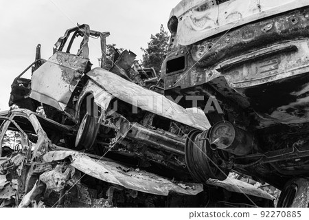 Shot and burned cars during the war in Ukraine, black and white photo 92270885